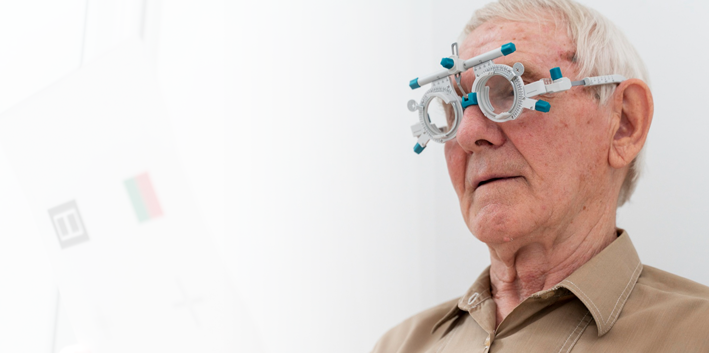 Elderly man wearing vision testing glasses, representing affordable vision care options for seniors aged 50 to 85.