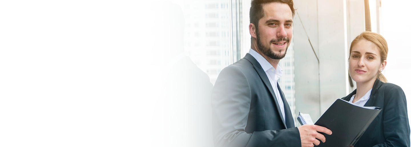 Licensed insurance agents smiling and holding a folder, representing Amerus Financial's commitment to integrity and community service.