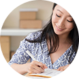 Woman writing notes, representing personalized service and employee engagement in group insurance solutions by Amerus Financial.