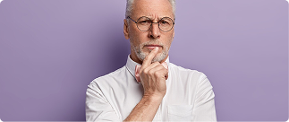 Thoughtful older man in glasses considering Indexed Universal Life insurance options and strategies.