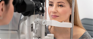 Woman undergoing an eye exam with an optometrist, highlighting the importance of vision care for seniors in dental and vision insurance discussions.