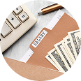 Keyboard, pen, and cash with a labeled folder titled "SALARY," symbolizing financial documentation relevant to private health insurance options.