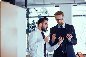 Business professionals discussing group insurance strategies and benefits in a modern office setting.