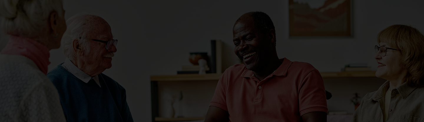 Group of diverse seniors engaged in a joyful conversation, emphasizing community and support for retirement planning.