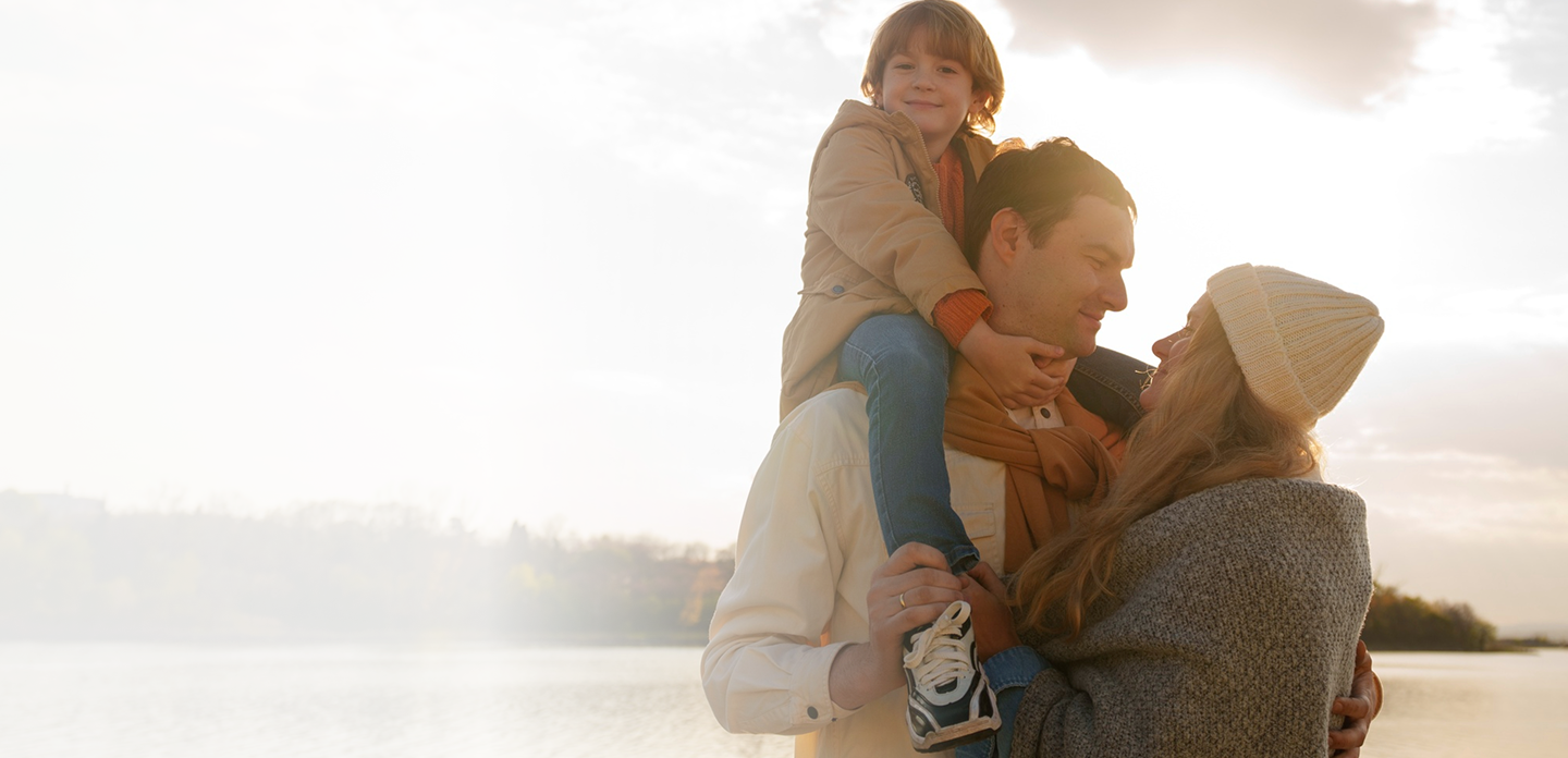 Family enjoying a moment together by the water, emphasizing love and connection, reflecting the importance of affordable life insurance from Amerus Financial.