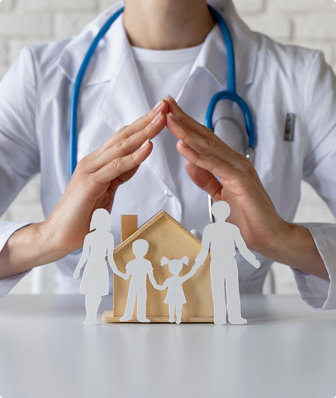 Doctor's hands forming a protective gesture over paper cutouts of a family and a house, symbolizing affordable life insurance and protection for families, as emphasized by Amerus Financial's offerings.