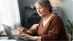 Senior woman using a laptop to explore Medicare options and enrollment information.