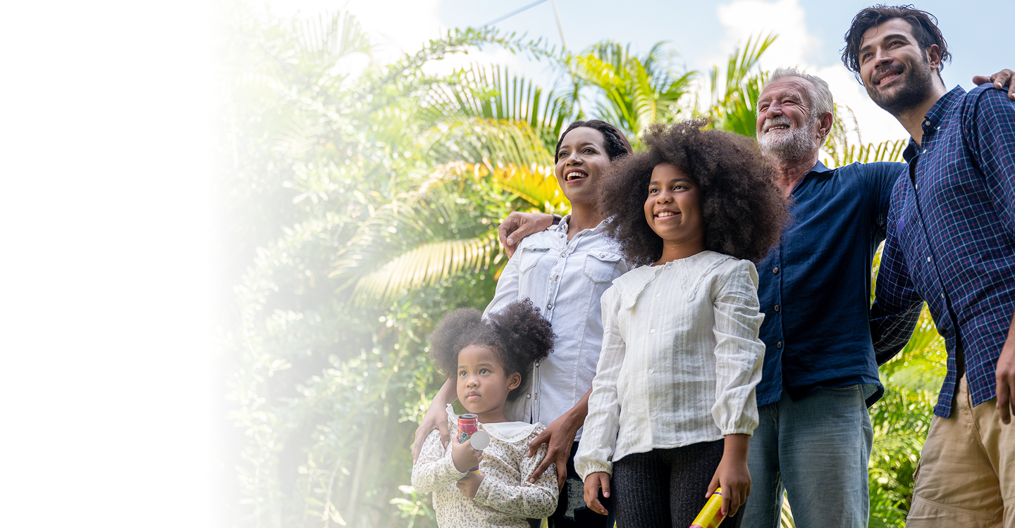 Family smiling together outdoors, representing community and health, emphasizing connection and support, relevant to affordable health insurance options through Amerus Financial.