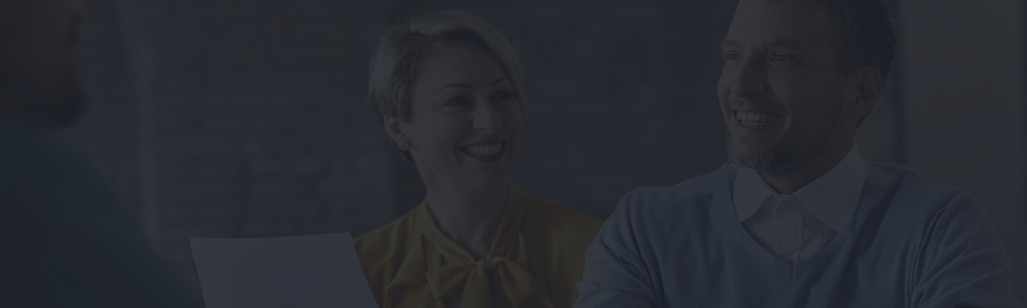 Smiling couple engaged in a discussion, emphasizing personalized guidance and support in financial planning and insurance.