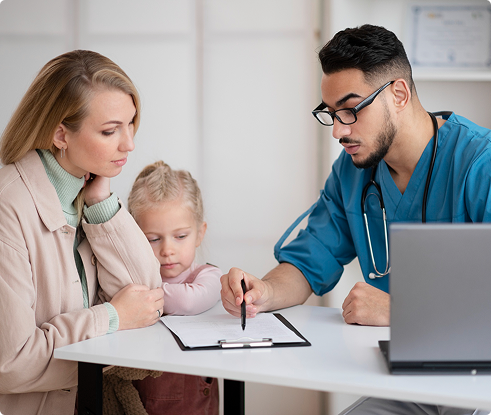 Mother and young daughter consulting with a healthcare professional, discussing private health insurance options, with a laptop and documents on the table.