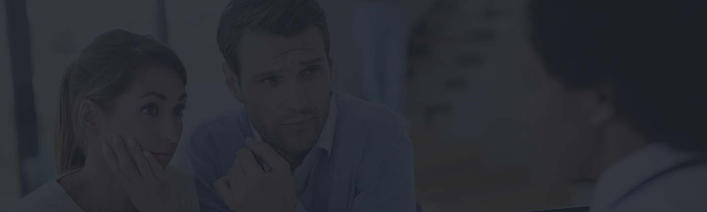 Couple discussing personal insurance options with a licensed advisor, emphasizing tailored coverage solutions.