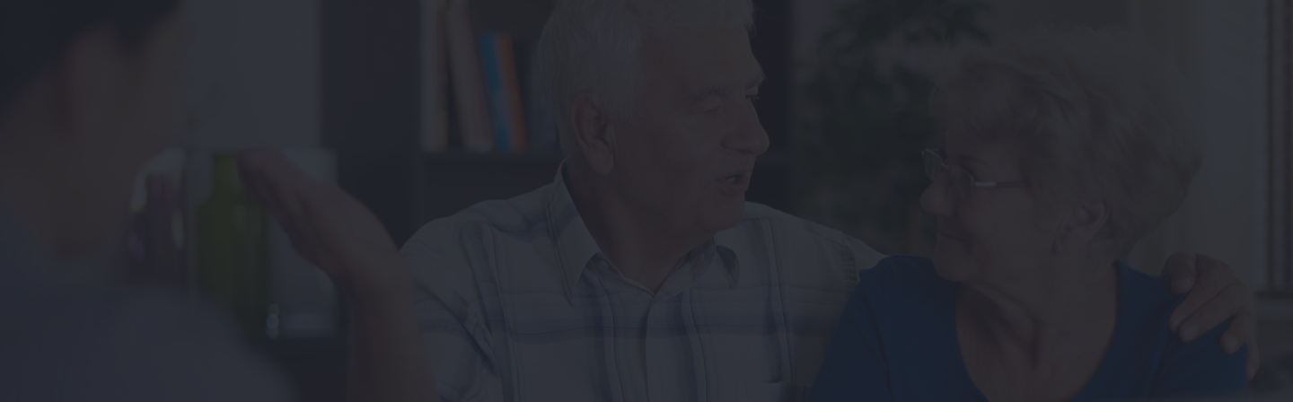 Senior couple engaging in conversation with a licensed advisor, discussing insurance options and coverage tailored for seniors.